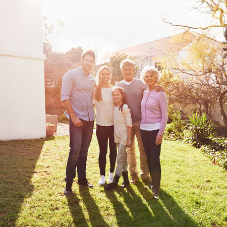 They stick together like glue. A full length portrait of a happy multi-generation family standing...