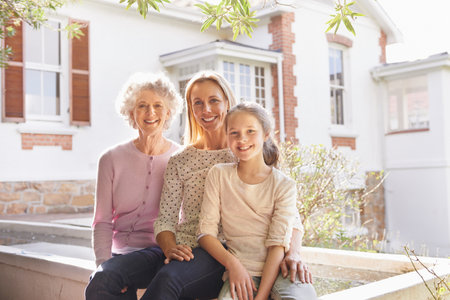 Three generations of happiness. A portrait of three generations of women sitting together.の写真素材