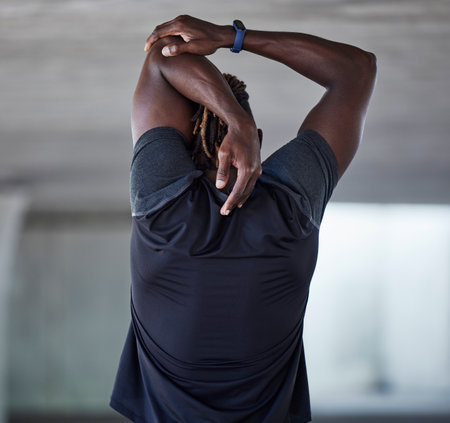Black man, back and stretching fitness outdoor for sports workout, training warm up and runner exercise motivation. African athlete, arms stretch and cardio performance wellness or body muscle careの写真素材