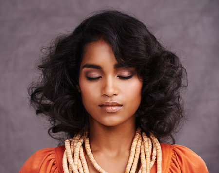 The history of her beauty lies in her heritage. Studio shot of a beautiful young woman posing with...