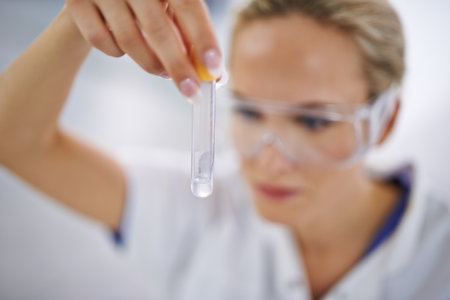 Discovering new medical frontiers. A young scientist conducting lab tests.の写真素材