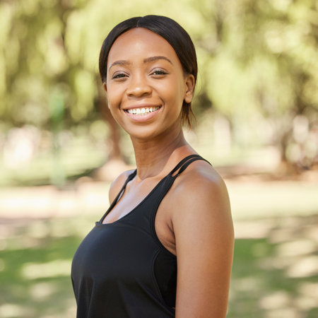 Park, fitness or portrait of a black woman in exercise workout or training in nature with goals. Wellness, face or healthy gen z girl with a calm, peaceful or happy smile in Nigeria with freedomの写真素材