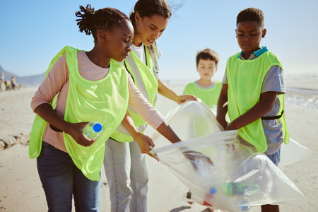 Diversity, beach cleaning and plastic recycling for teamwork, pollution ecology and environmental change collaboration. Eco friendly team, interracial people and ocean garbage recycle togetherの写真素材