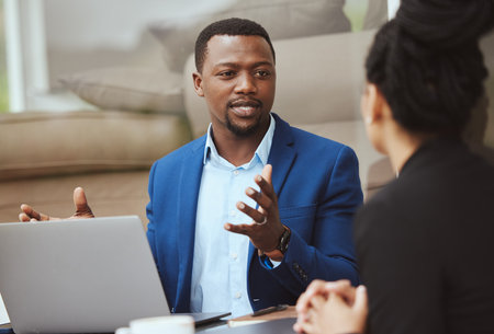 Laptop, meeting and financial advisor with a business black man and woman client talking portfolio growth. Computer, finance and accounting with a male and female employee working on investmentの写真素材