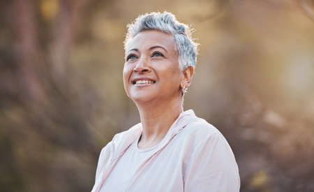 Senior woman, nature and thinking while outdoor for freedom, happiness and a healthy lifestyle with...