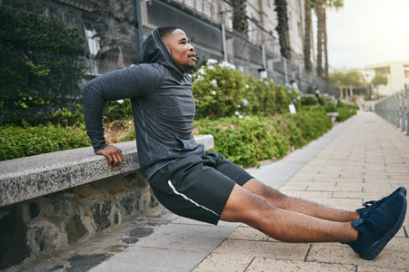 Exercise, triceps dips and black man in city, street or outdoors. Sports, thinking and young male...