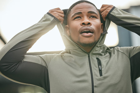Fitness, vision and hoodie with a sports black man getting ready for a workout, exercise or running....