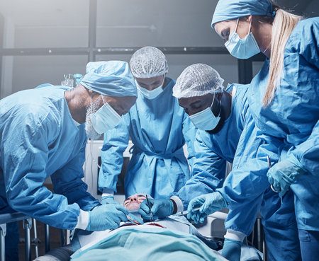 Doctors, surgery and collaboration with a medicine team in scrubs operating on a man patient in a hospital. Doctor, nurse and teamwork with a medical group in a clinic to perform an operationの写真素材