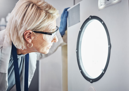 Scientist, worker or laboratory autoclave equipment in medical research, vaccine temperature control...