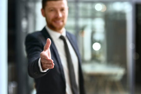 Your business is welcome here. a businessman extending his arm for a handshake.