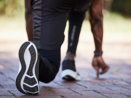 Sneakers, runner and fitness with black man start to run outdoor, healthy lifestyle and wellness...