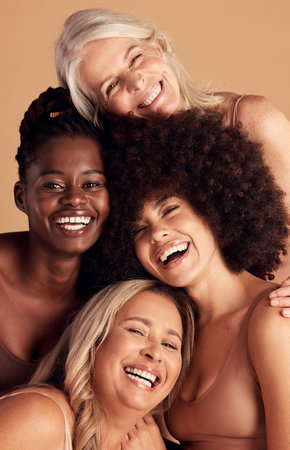 Diversity, beauty and natural with woman friends in studio on a beige background to promote skincare. Portrait, face and smile with a happy female and friend group indoors for luxury cosmeticsの写真素材