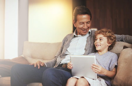 You should show me how that thing of yours works. A grandfather and grandson sitting on the sofa...