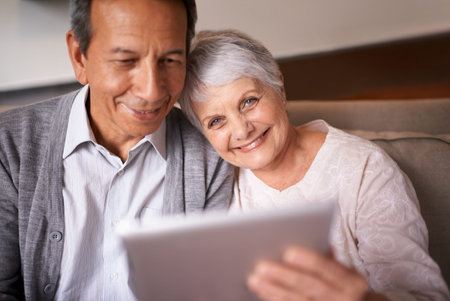 Getting to know the world of technology. A senior couple sitting with a digital at home.