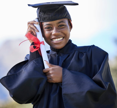 Graduate, certificate with education and black woman portrait, university success and graduation with achievement. Student in graduation cap outdoor, motivation and future, happy woman with diplomaの写真素材
