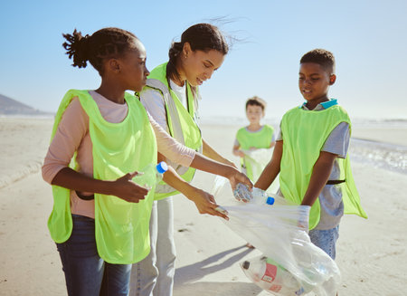 Children, beach and plastic recycling teamwork for pollution ecology and environmental change collaboration. Eco friendly team, diversity and ocean garbage recycle together for community cleaningの写真素材