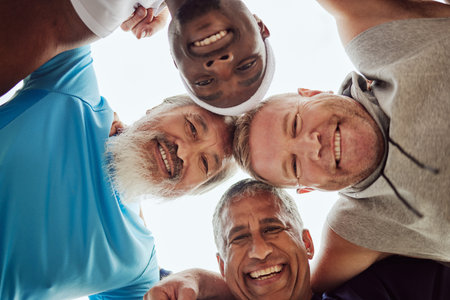 Motivation, senior or friends with fitness goals, support or hope in huddle bonding in training, exercise or workout. Low angle, partnership or healthy group of elderly or happy sports men portraitの写真素材