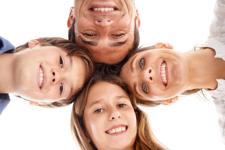 Family huddle. Low-angle shot of a happy family of four standing in a huddle.の写真素材