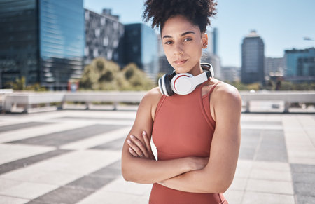 Music, fitness and black woman in a city portrait for workout, exercise or training motivation, mental health and wellness Face of a sports athlete with headphones technology for audio subscriptionの写真素材