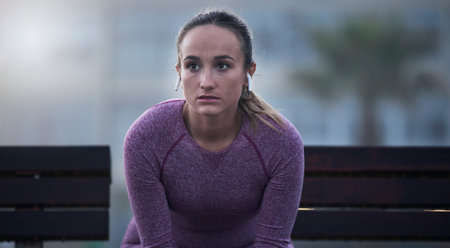 Focus, thinking and fitness woman outdoor for city workout and wellness exercise in marathon...