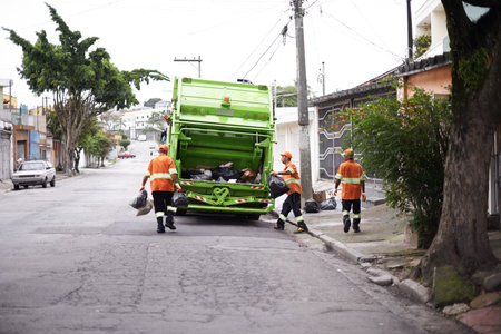 Garbage collection day. a garbage collection team at work.の写真素材