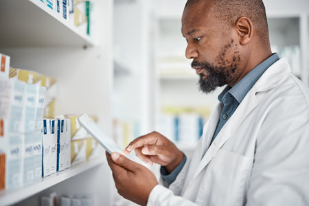 Pharmacy, medicine and black man with tablet to check inventory, stock and medication for online prescription. Healthcare, medical worker and pharmacist with pills, health products and checklistの写真素材
