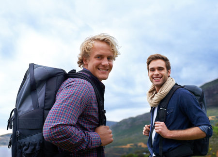 Two men of adventure. Two male backpackers exploring nature together.