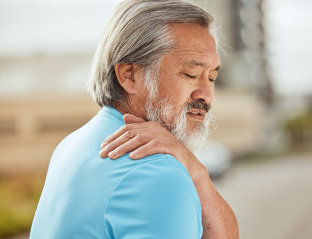 Fitness, shoulder pain and senior man with workout, exercise or running health, stress and muscle risk of strong, challenge or problem training. Sports injury, back pain and athlete medical emergencyの写真素材