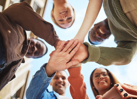 Friends smile, hands together in huddle and group diversity, team building in circle from below....
