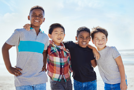 Beach portrait, diversity and children hug on Miami Florida travel vacation for calm, freedom or outdoor peace. Blue sky, ocean sea and happy youth kids or young friends on summer USA holiday for funの写真素材