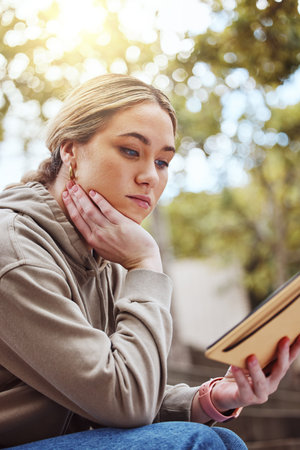Thinking woman, notebook or reading on college campus, university park or school in education,...