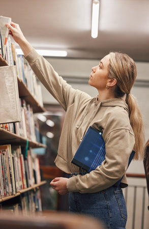 University, book search or student in library at college or school campus bookshelf for learning or...