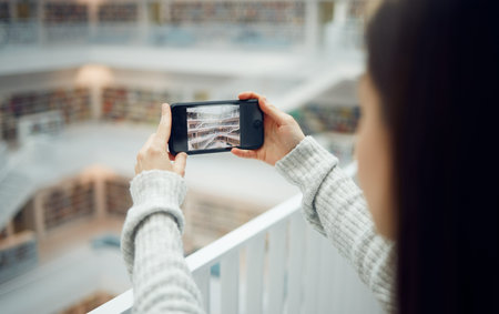 Library, student and woman taking pictures with phone for social media. Education scholarship, tech...