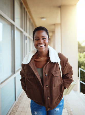 Black woman, student and portrait smile for university, education or vision for development at the campus. Happy African American woman smiling for college, scholarship or higher education outsideの写真素材