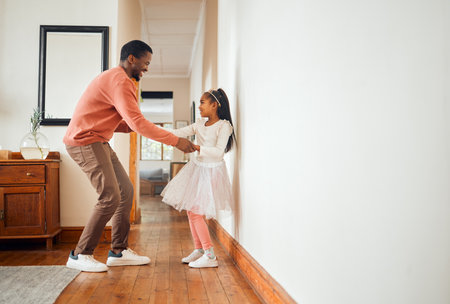 Dance, happy and ballet with father and daughter holding hands for learning, support and bonding. Princess, teaching and music with dad and girl in black family home for freedom, wellness and helpingの写真素材