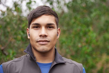 Enjoying the outdoors. Portrait of a young trail runner on a mountain path.