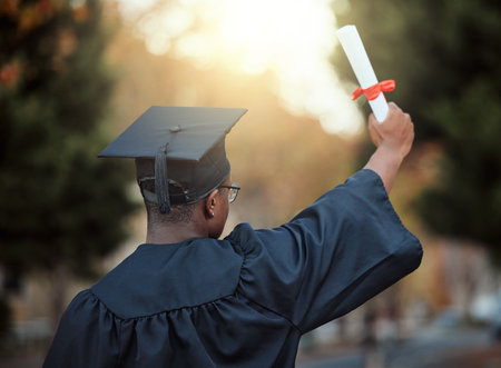 University graduation, certificate and back view of black man with motivation for learning goals, achievement or future. Male graduate student, diploma and celebration of success in college educationの写真素材