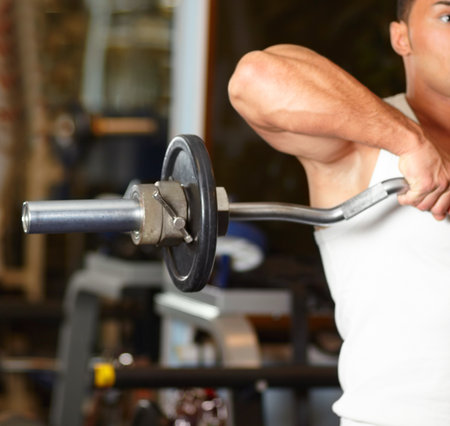 Handsome man at the gym doing exercises. Handsome sportive man at the gym doing exercises.の写真素材
