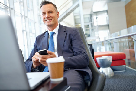 Businessman smile, laptop and smartphone with company communication or social media with coffee...