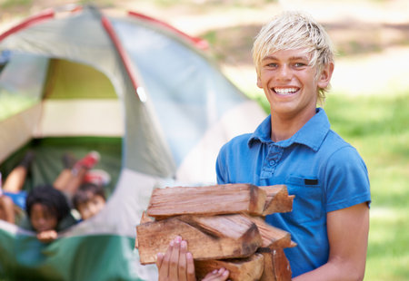 Claiming his camping spot. A boy standing in front of his campsite.
