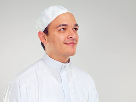 Islam, culture and portrait of muslim man with smile on face in ramadan isolated on grey background....