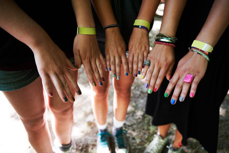 Personal styles. Cropped image of a group of young girls hands and their colourful nails.