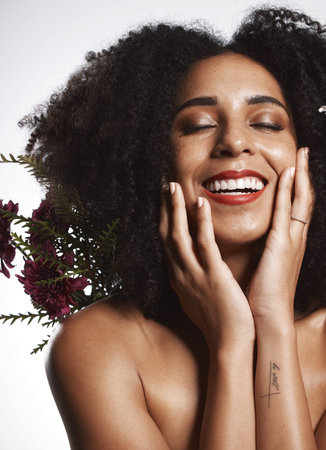 Peace, skincare and makeup girl with flowers satisfied with beauty and glowing texture routine. Aesthetic, health and wellness of confident black woman with beautiful smile in white studio.の写真素材