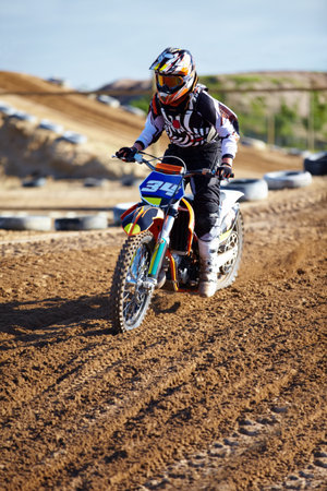 Riding is both relaxing and exciting. A motocross rider on the track.の写真素材