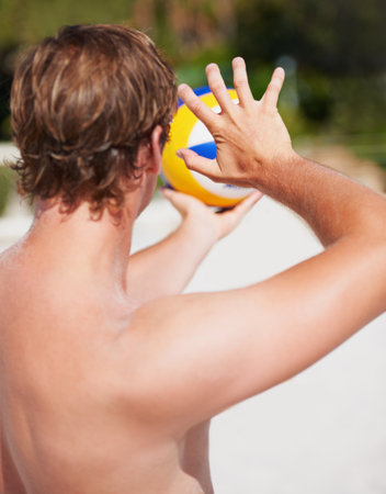 Hes got a mean serve. a beach volleyball game on a sunny day.の写真素材