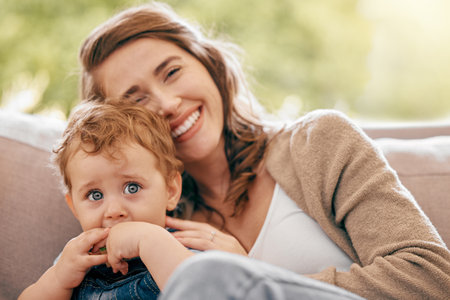 Son, youll outgrow my lap, but never my heart. a young mother bonding with her baby boy on the sofa at home.の写真素材