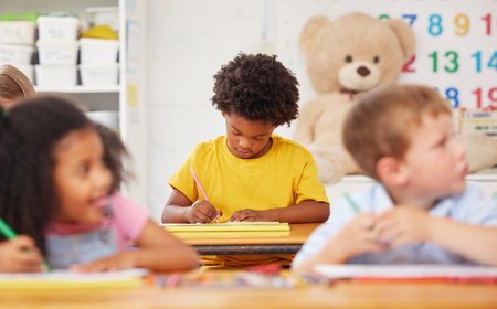 Staying focused in class. preschool students colouring in class.の写真素材