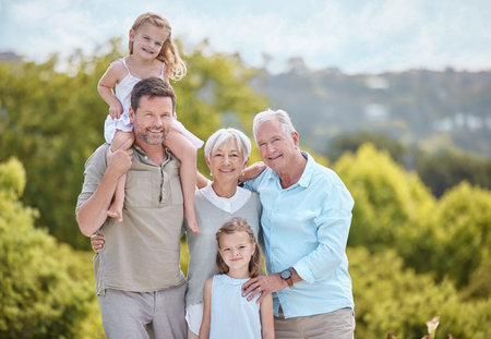 The cement that binds closer together. a family standing together in a park.