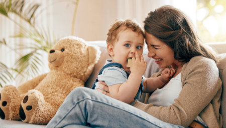 I cherish his hugs. a young mother bonding with her baby boy on the sofa at home.