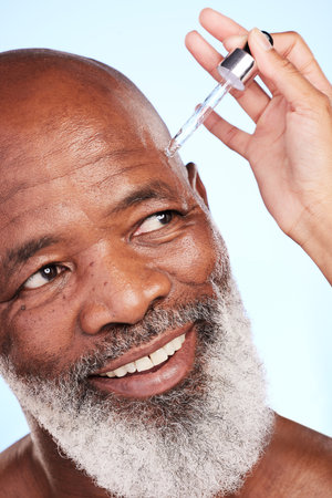 Just you watch. a handsome mature man posing in studio against a blue background.の写真素材